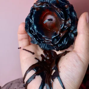 Black wax play candle with a bold red core, designed for intense sensory contrast and deep visual appeal.